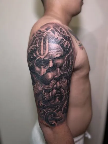 Healed black and grey Poseidon shoulder tattoo