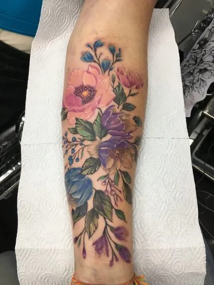 Colour realism peony and wildflower bouquet on the forearm