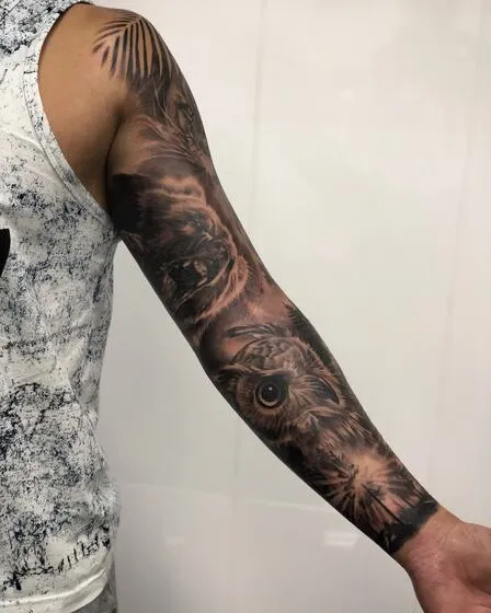 Realism full sleeve with a grizzly bear and an owl in a forest
