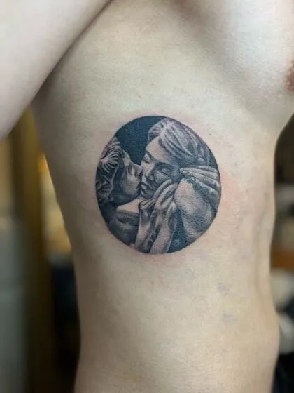 Black and grey Cupid and Psyche marble sculpture tattoo on the ribs