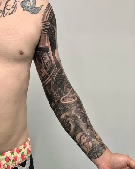 Black and grey full sleeve with cathedral architecture, a praying angel and a cherub