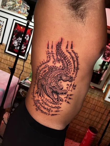 Crocodile yantra with Khom script on the ribs, side view in the studio
