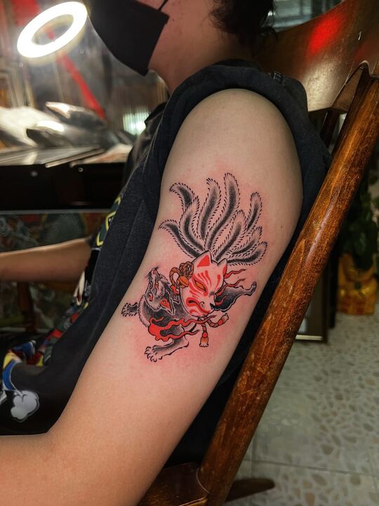 Red nine-tailed fox tattoo