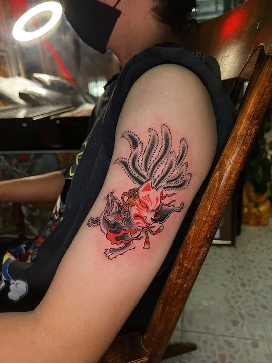 Red nine-tailed fox tattoo