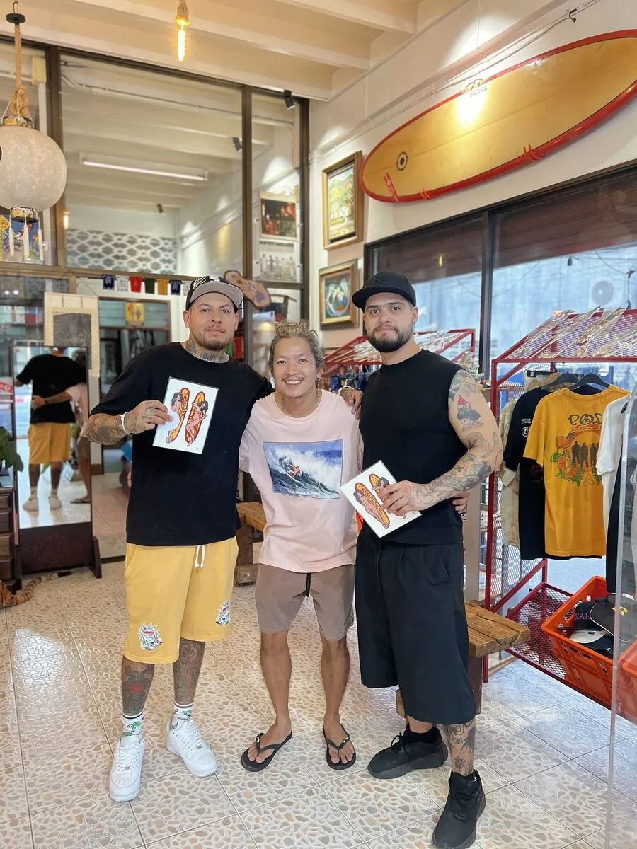 Artists holding art prints in the shop