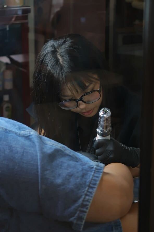 An artist at work in glasses and gloves