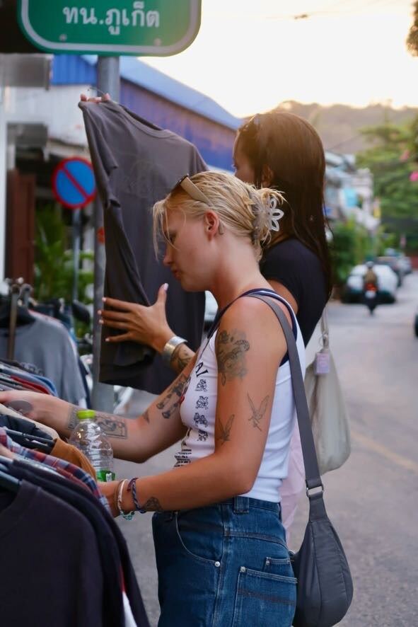 Browsing vintage shirts outside on the Phuket street